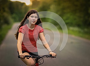 Teenager girl with bicycle country summer outdoor portrait