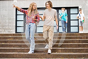 Teenager girl and boy going home after school