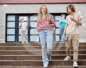 Teenager girl and boy going home after school