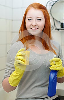 Teenager girl cleans bathroom