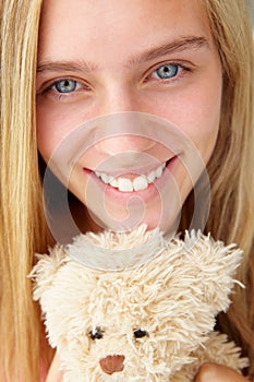 Teenager girl close up with teddy bear photo