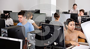 Teenager girl copying documents in computer class