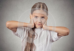 Teenager girl covering ears with hands