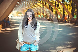 Teenager girl in denim shorts and sunglasses