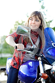 Teenager girl drive blue motorcycle