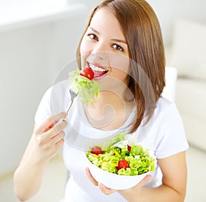 Teenager girl eating salad