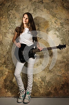 Teenager girl with electric guitar