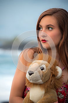 Teenager girl with her lion plush toy