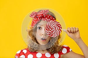 Teenager girl holding red lollipop