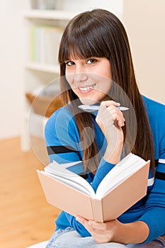 Teenager girl home - happy student with book