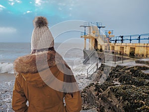 Teenager girl looking at Blackrock diving board, Selective focus,