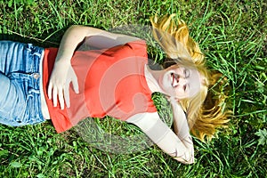 Teenager girl lying in grass