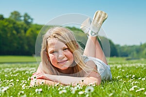 Teenager girl lying on grass