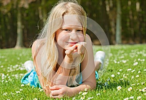 Teenager girl lying on grass