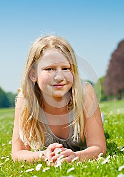 Teenager girl lying on grass