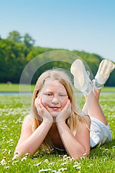 Teenager girl lying on the grass