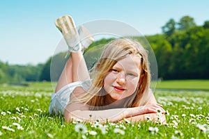 Teenager girl lying on the grass