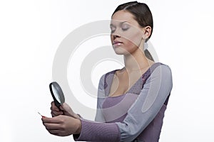 Teenager girl with magnifying glass