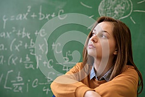 Teenager girl in math class overwhelmed by the math formula.