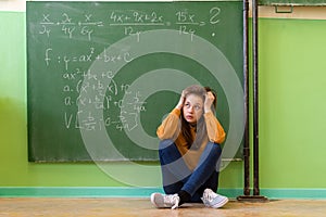 Teenager girl in math class overwhelmed by the math formula. Pressure, Education concept.