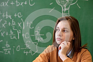 Teenager girl in math class overwhelmed by the math formula. Pressure, Education concept.