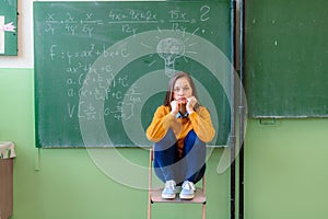 Teenager girl in math class overwhelmed by the math formula. Pressure, Education, Success concept.