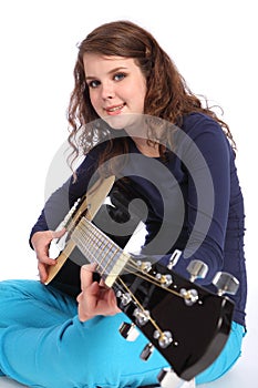 Teenager girl musician playing acoustic guitar