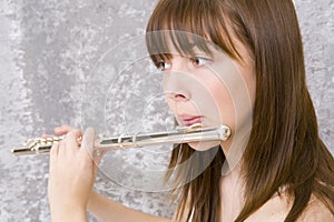 Teenager girl playing flute photo