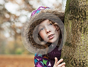 Teenager girl poking around a tree