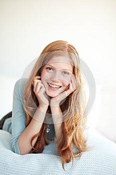 Teenager, girl and portrait relax in bed smile for weekend rest, casual happy day or home comfort. Female person, face