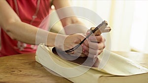 Teenager girl praying to God holding a wooden cross,focus on cross.