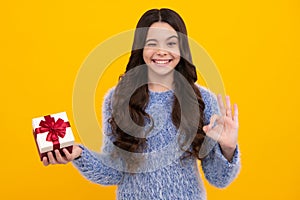 Teenager girl with present gift. Greeting and gifting.