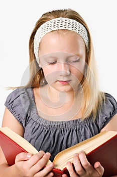 Teenager girl reading a book isolated on white