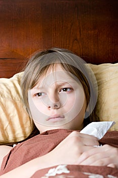 Teenager girl sick with flu lying in bed