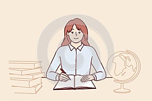 Teenager girl sits at school desk with globe and books to gain new knowledge and quality education