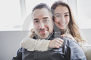 Teenager girl sitting on window with father