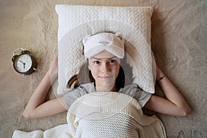 Teenager girl sleeping on white pillow at home