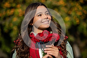 teenager girl smile with autumn flowers bouquet. teenager girl with autumn flowers