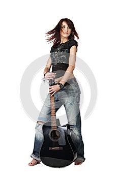 Teenager girl standing with acoustic guitar