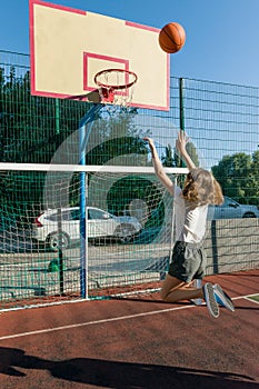 Teenager girl street basketball player on the basketball court.