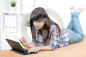 Teenager girl studying at home lying on sofa