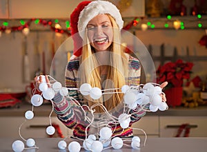 Teenager girl untangling christmas lights