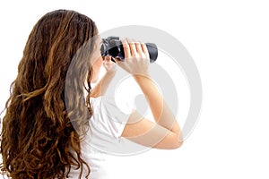 Teenager girl watching through binocular