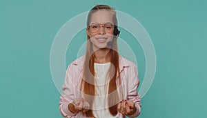 Teenager girl wearing headset, freelance worker, call center or support service operator helpline