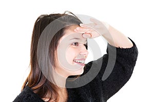 Teenager girl on white background looking far away with hand to look something