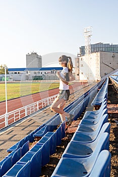 Teenager girl working out at the staduim running down the stairs