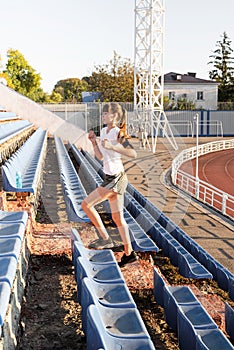 Teenager girl working out at the staduim running up the stairs