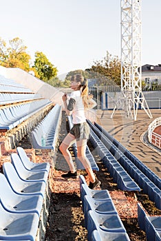 Teenager girl working out at the staduim running up the stairs