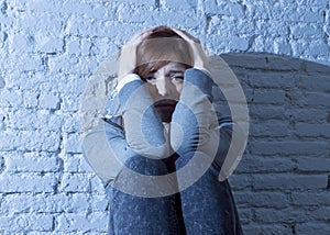 Teenager girl or young woman feeling sad and scared looking overwhelmed and depressed photo
