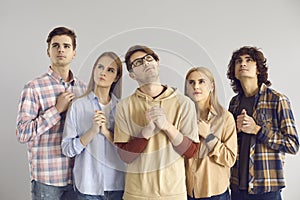 Teenager group praying with hope or begging together studio headshot portrait